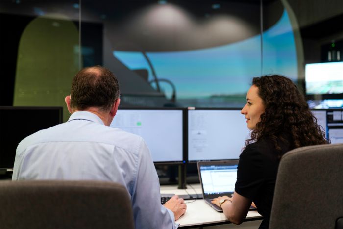 man and woman in front of computer